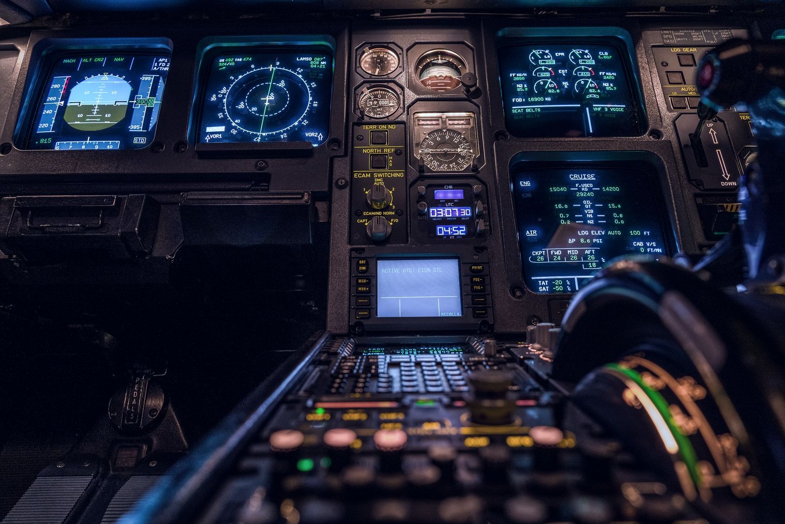 Flight deck of a business jet at night, instrument panels lit
